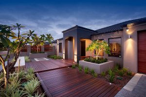 Front garden with timber deck path entrance raised garden with frangipani and garden lighting